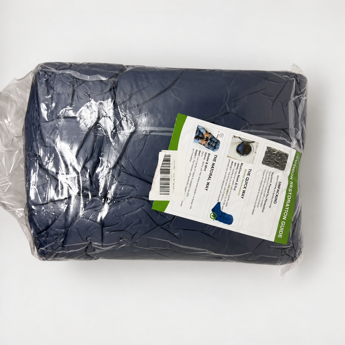 Actual navy cushions in protective packaging; background cleaned